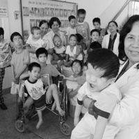 A_vietnamese_Professor_is_pictured_with_a_group_of_handicapped_children.jpg