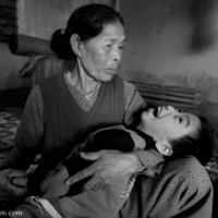 A_vietnamese_woman_takes_care_of_her_grandson.jpg