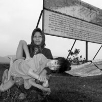 Two_Vietnameses_pose_in_front_of_the_billboard.jpg